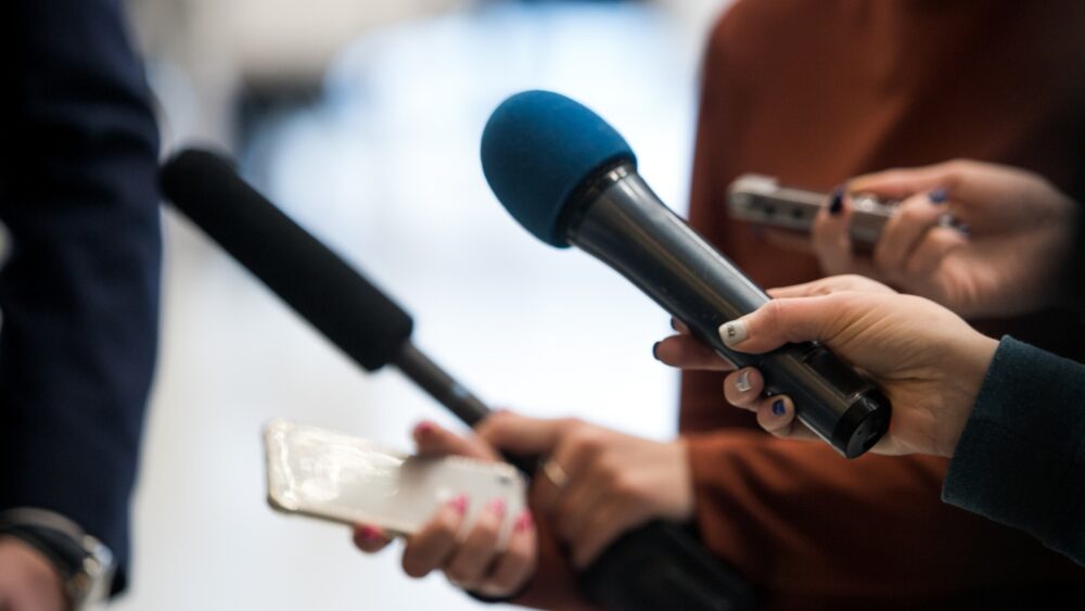 Journalist interviewing people on the street