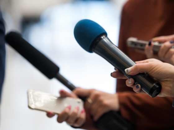 Journalist interviewing people on the street